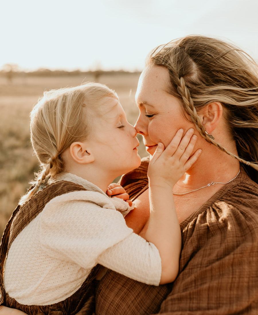 Jessmyn nose to nose with her daughter, both laughing